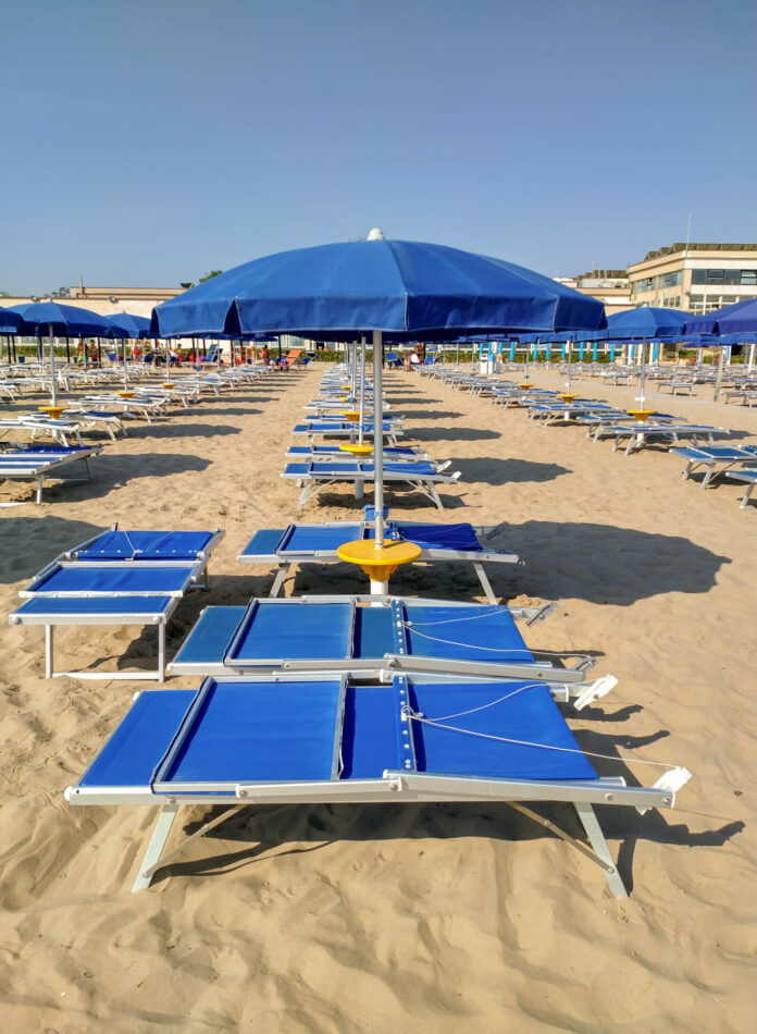 Rimini - Blue open umbrella and sunbeds