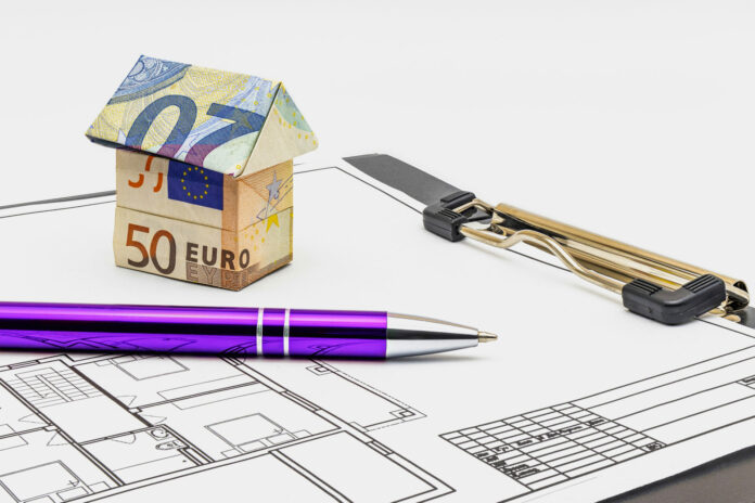 Purchase and sale of housing Mortgage for the purchase of a house Rental Property House made of euro banknotes and a ballpoint pen on the project of the future house Close-up Copy space
