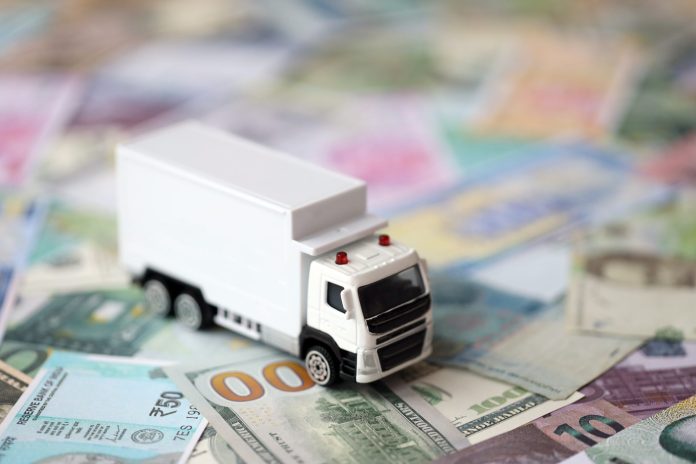 delivery-truck-many-banknotes-different-currency-background-trucking-moving-concept